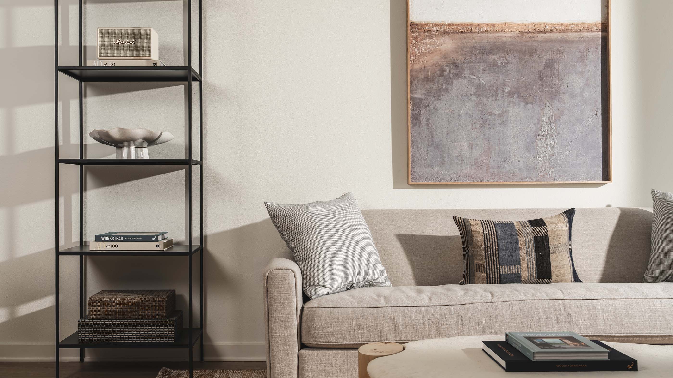 Sunlit modern living room with a fireplace, TV, sectional sofa, and potted plant.