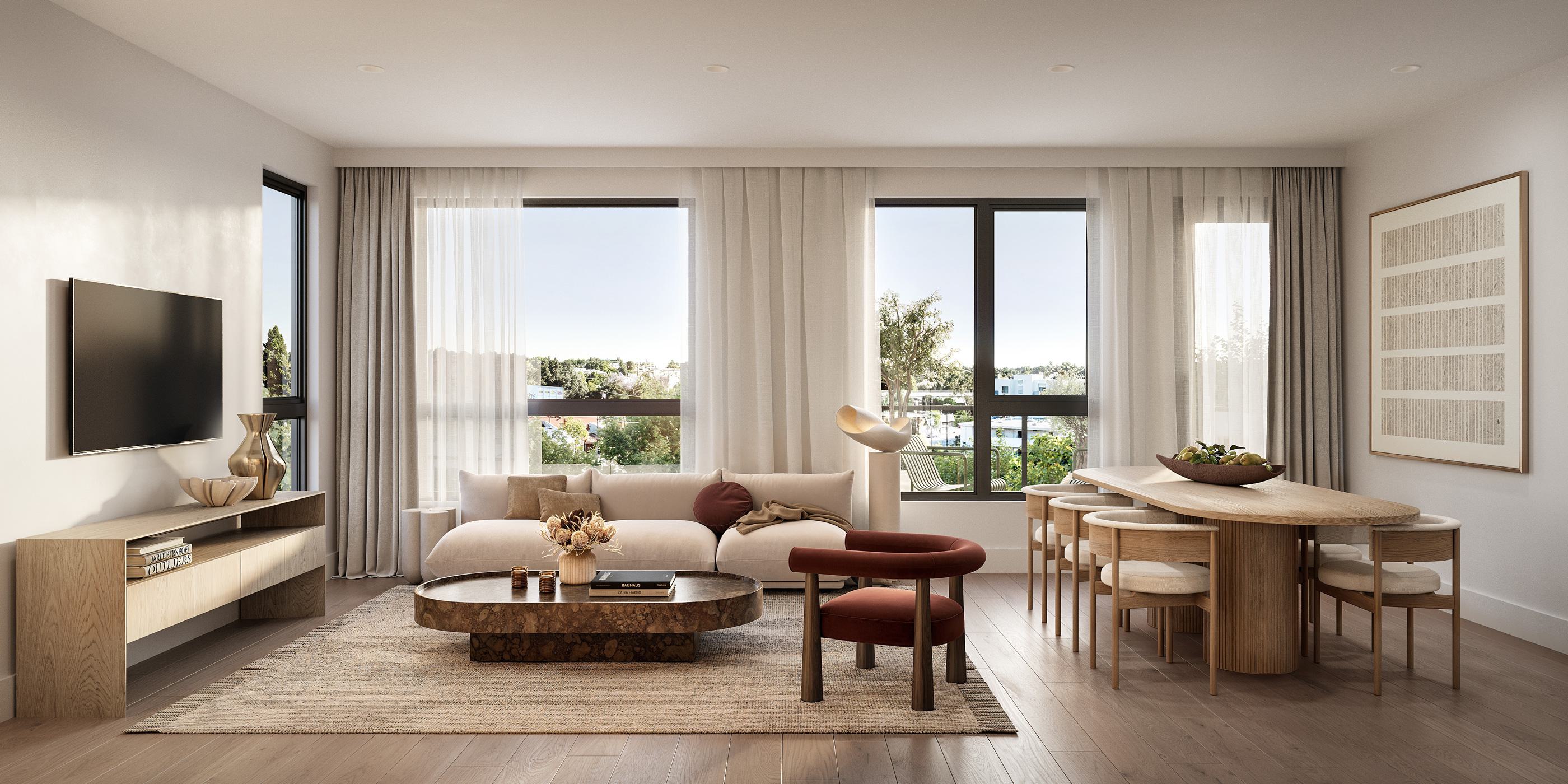 Open-concept living and dining area at Maris with a low cream sofa, rust armchair, oval dining table, and large windows.