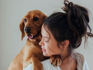 A woman hugging her dog