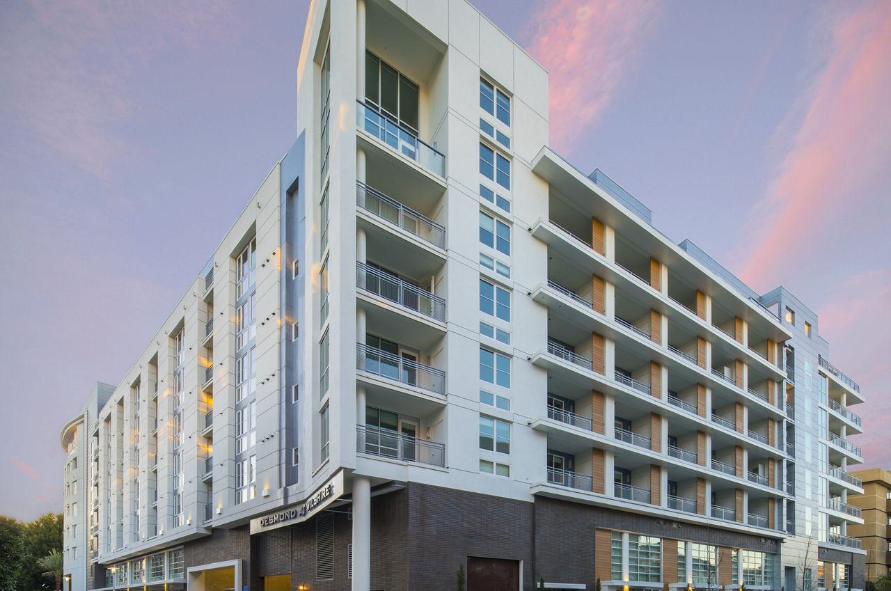 exterior shot of the Desmond Wilshire near sunset, highlighting balcony apartments