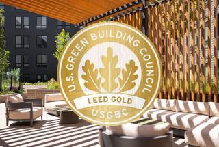 Green Building Council LEED Gold Logo over outdoor room at Forge Apartments