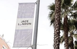 Banner reading Jack London Square near palm trees