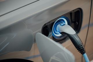 close up of an electric vehicle connected to a charging station