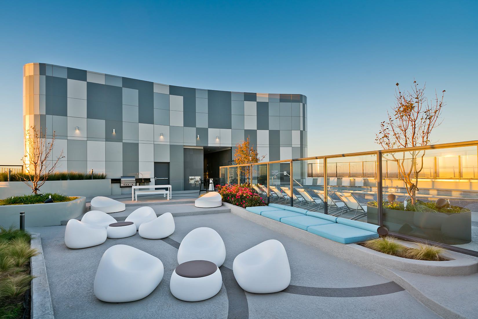 Modern luxury apartment rooftop terrace at Adaire in Tysons with contemporary lounge seating, pool deck, and scenic horizon views.