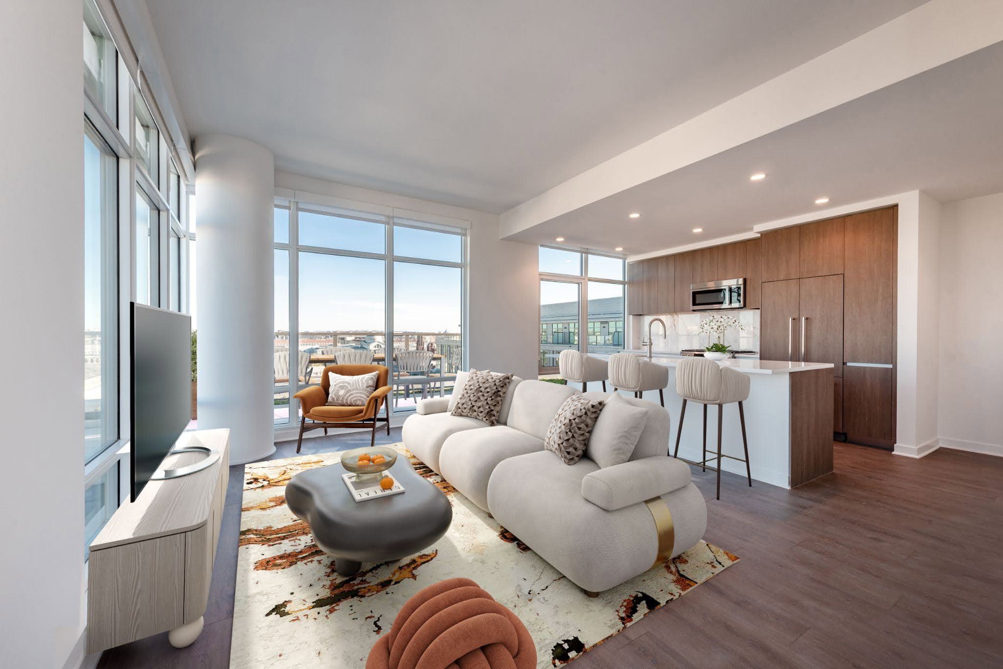 Sun-drenched Collection penthouse living space at Annex on 12th, showcasing panoramic floor-to-ceiling windows, a modern open layout, and a luxury kitchen.