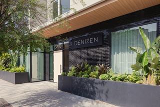 modern exterior of denizen apartments in Hillcrest San Diego with large windows and attractive planters and greener