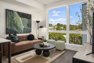 Bright apartment living room at The Cline featuring oversized windows with scenic views of the Fremont neighborhood.