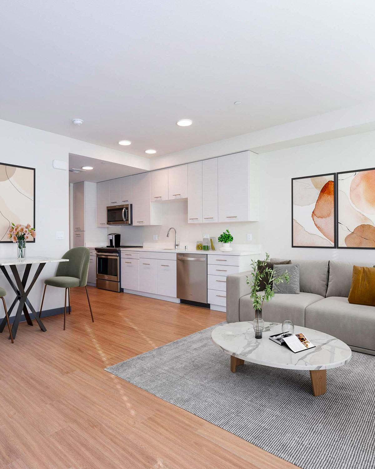 Modern apartment living room and open-concept kitchen with plank flooring at Artis Apartments in San Jose, California