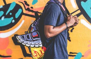 Man with a backpack walking by Street Art