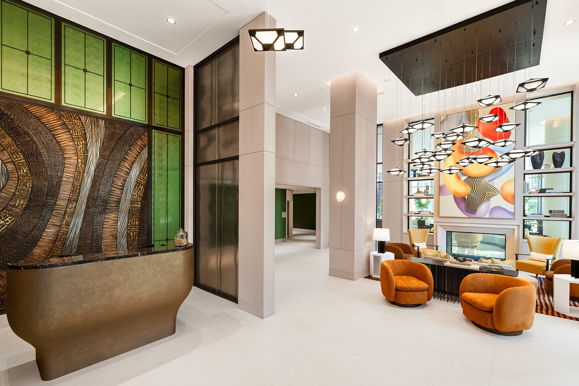 colorful, stylish building lobby at Aerie with soaring ceilings, soft lounge chairs, and original artwork