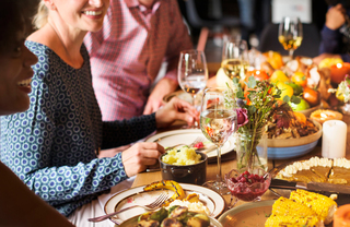 close up of friends sharing wine & thanksgiving dinner at a table - 15 Cliff Financial District luxury apartments