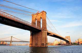 Upward view of the Brooklyn Bridge on a clear view day.