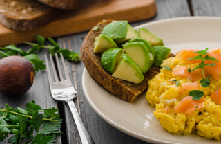 A plate of avocado toast and an omelette.