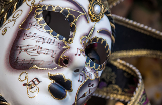 A close up of a white theater mask