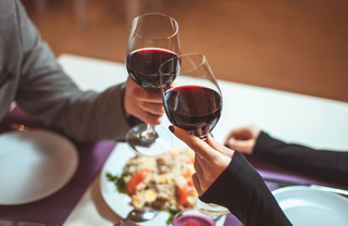 Toasting glasses of red wine