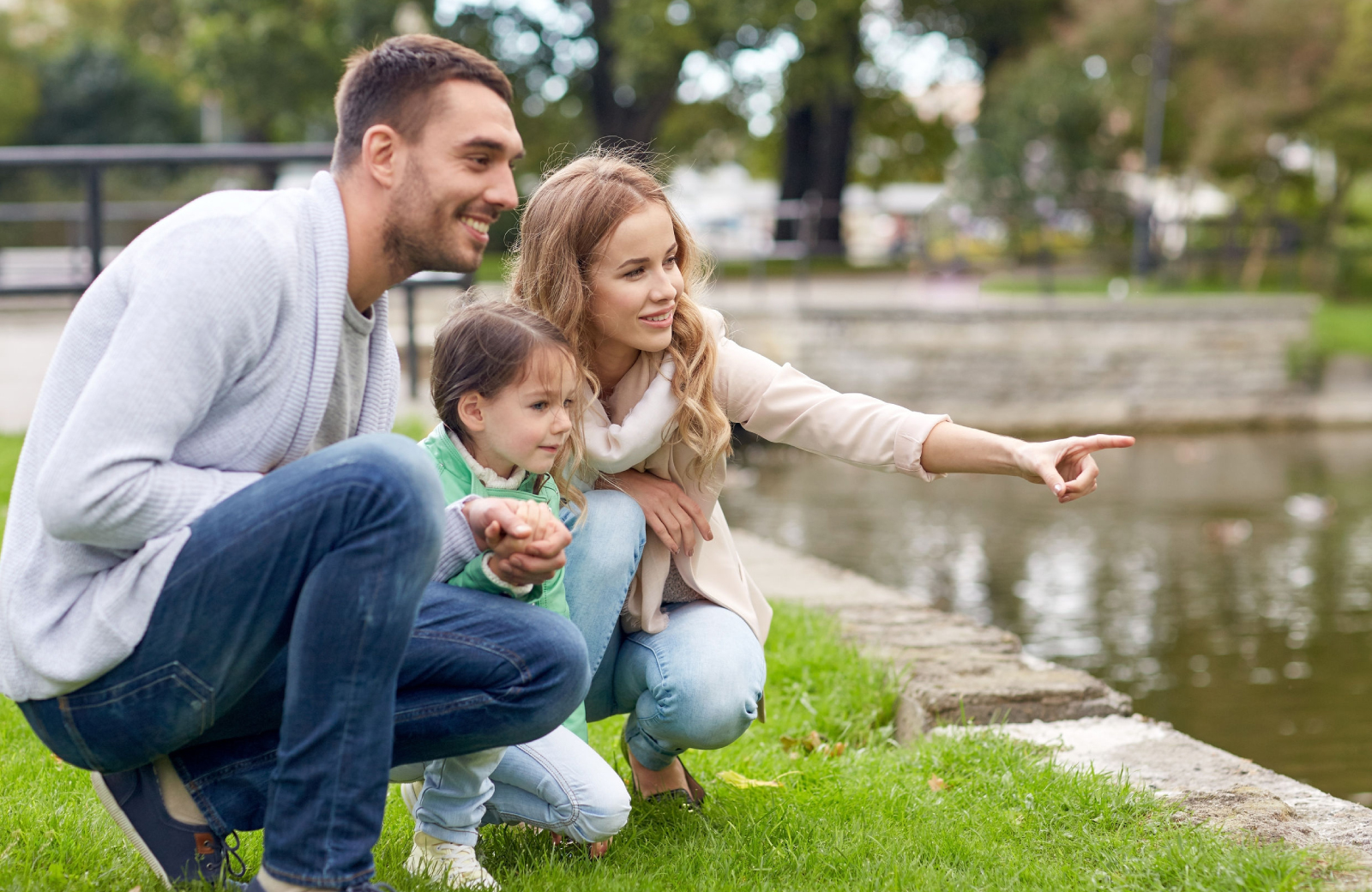 young couple with their little girl pointing out something interesting Stamford’s Downtown Parks - The Waypointe