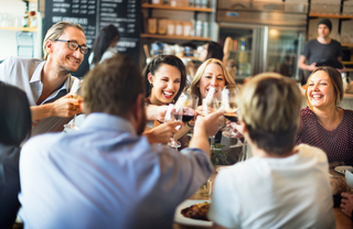 2 men & 4 women at Waypointe District toasting glasses of wine- The Waypointe Apts