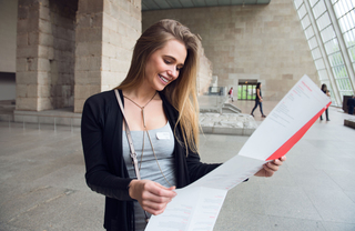 A museum patron looking at a map