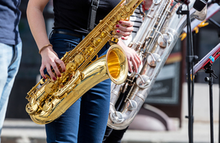A person playing the saxophone on stage