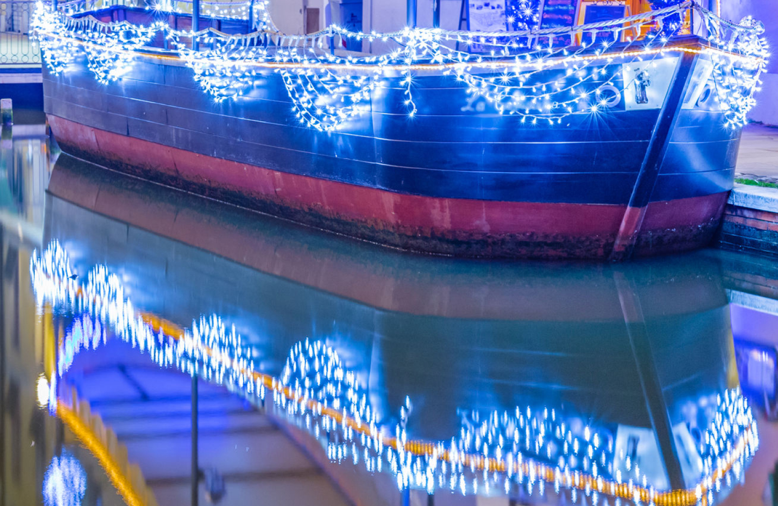 Boat decked out in blue holiday lights - The Vue