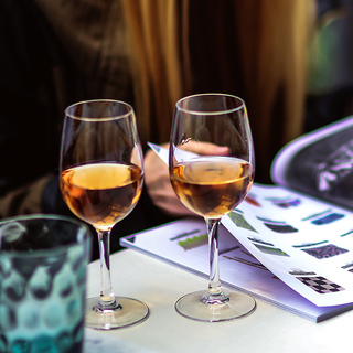 Two glasses of orange wine on a table