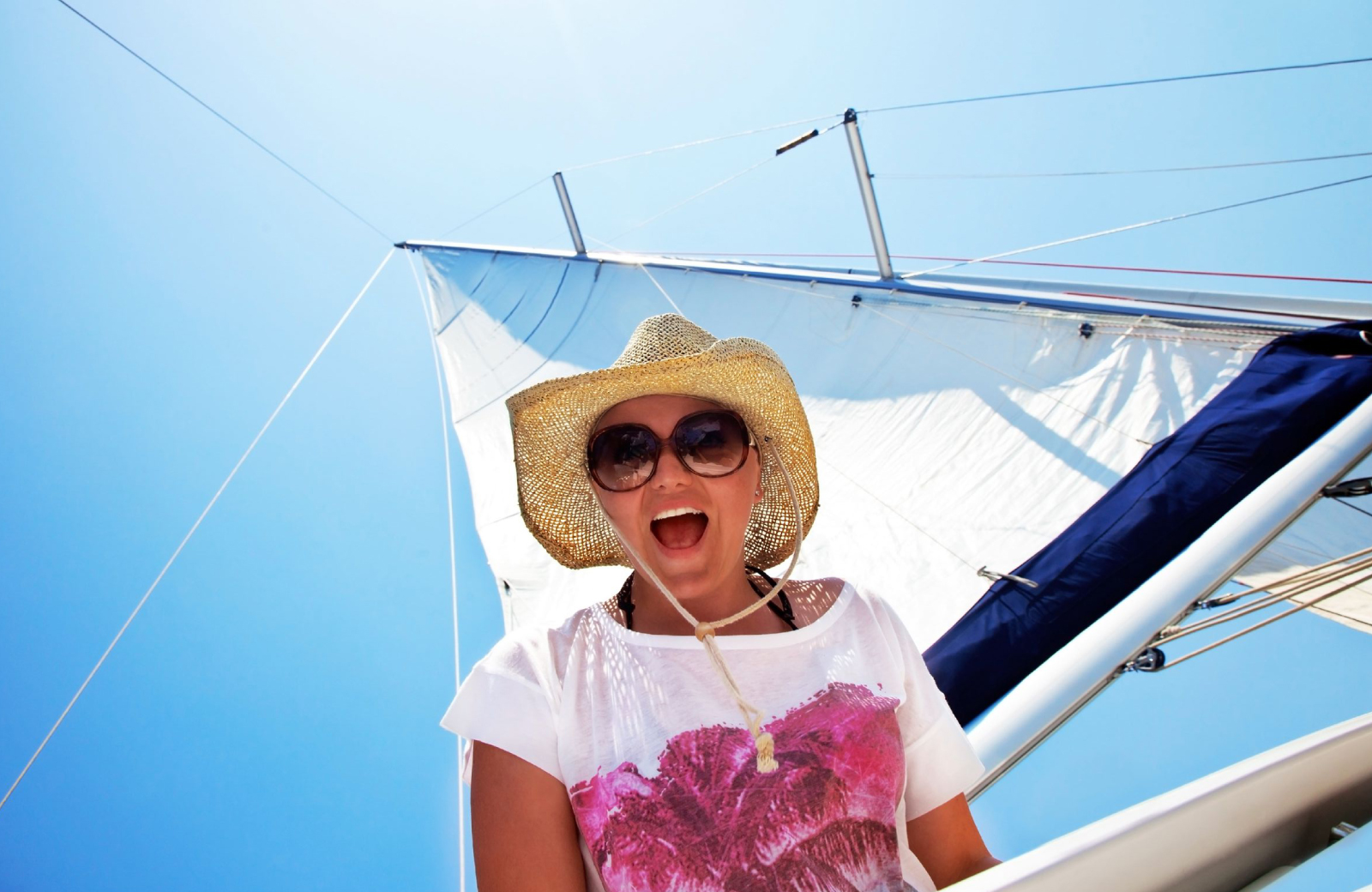 happy woman on a sailboat - sweetheart sail - the Vue