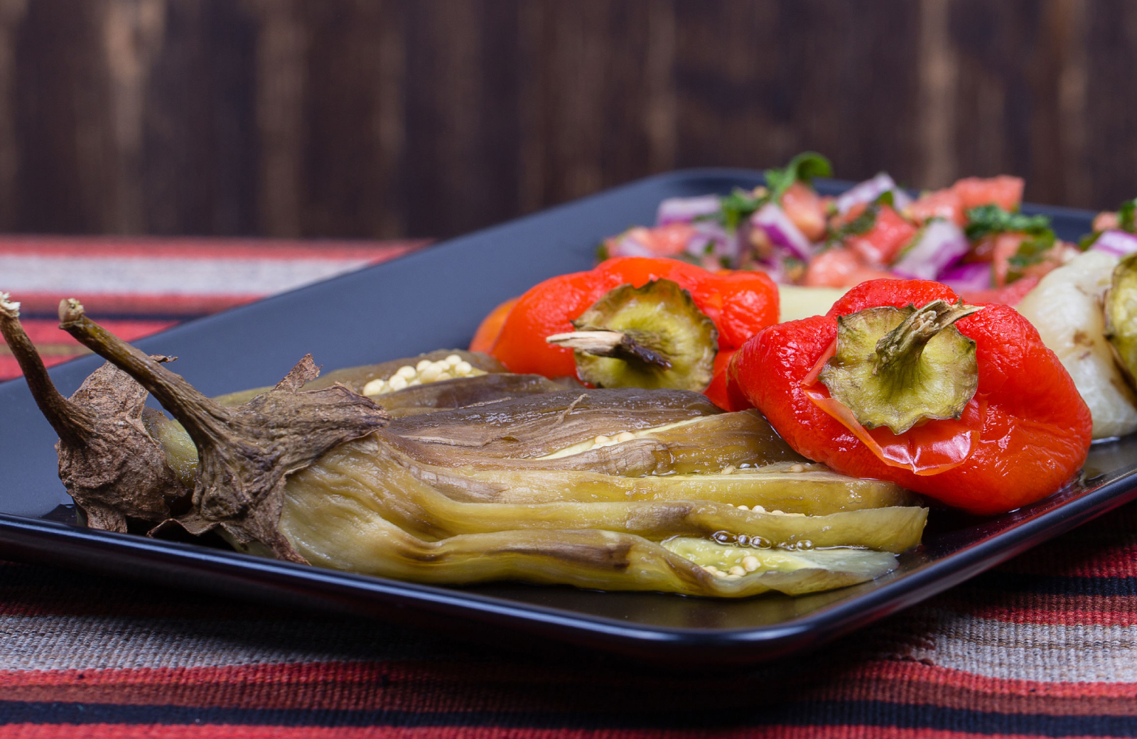 a plate of roasted red peppers and tamales at Norwalk Healthy Restaurants - The Waypointe Apts