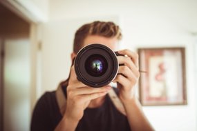 man holding a camera - The Waypointe blog