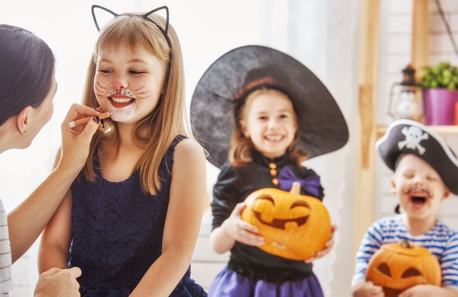 little girls in cat costume & witch costume getting ready for trick or treat - hyde square bellevue