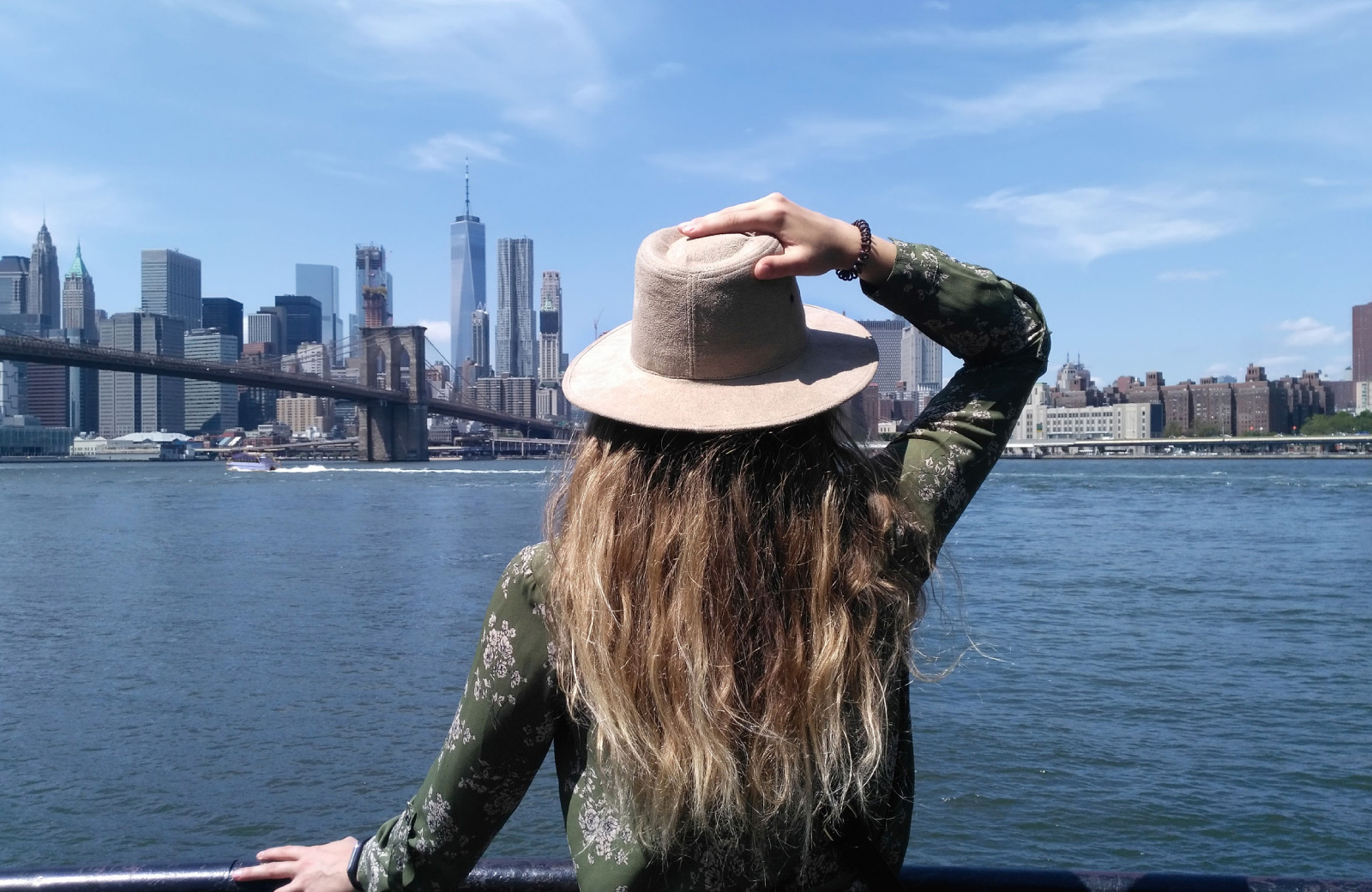 woman looking over sights along the Hudson river 15 cliff financial district ny