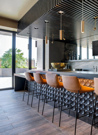Modern bar with counter seating in the resident clubhouse