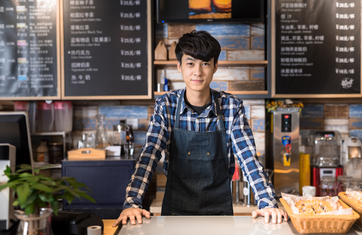 male barista at coffeeshop counter - Admirals Cove Alameda neighborhood