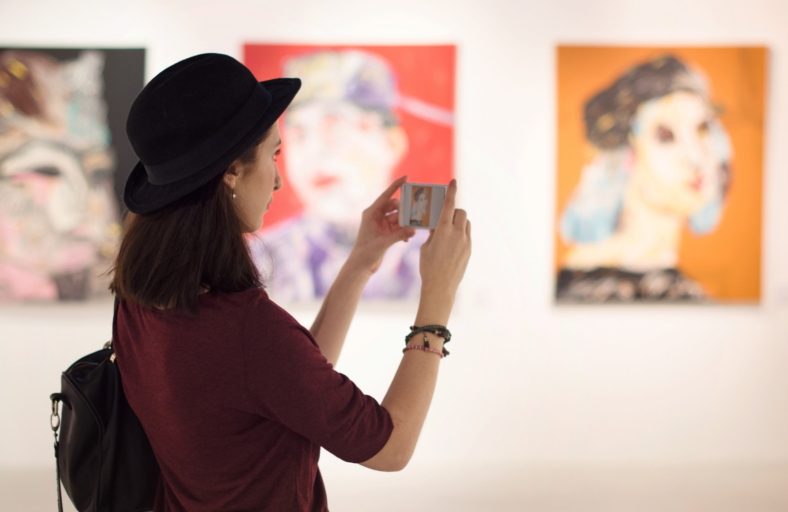 woman taking picture in art gallery the vue san pedro