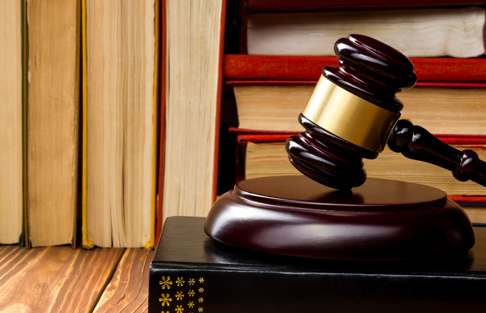 aw book with a wooden judges gavel