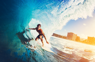 man riding a huge wave