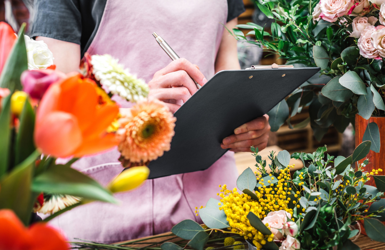 woman making a list among plants