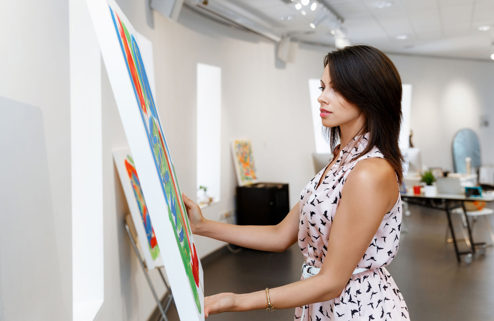 woman examining a painting