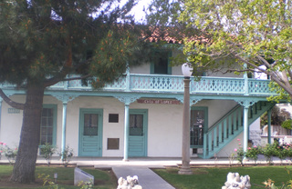 The aqua and white Casa de Lopez building exterior