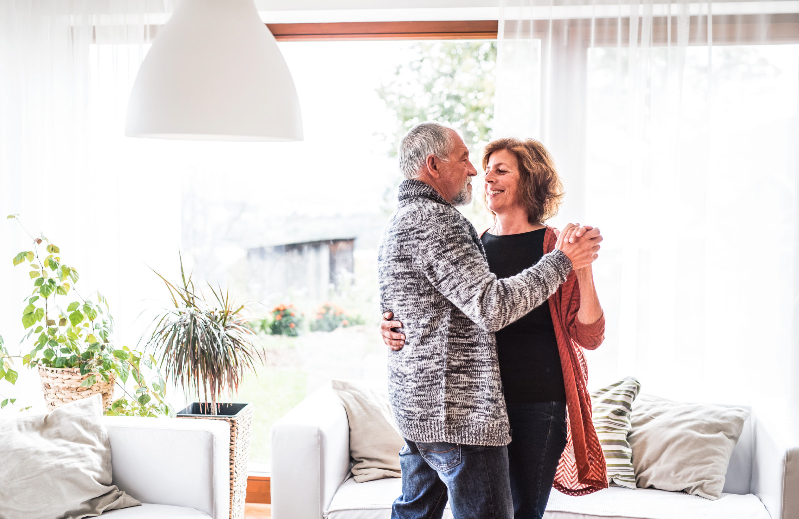 mature couple sweet dancing in the living room - The Madrid apts in Westchester LA