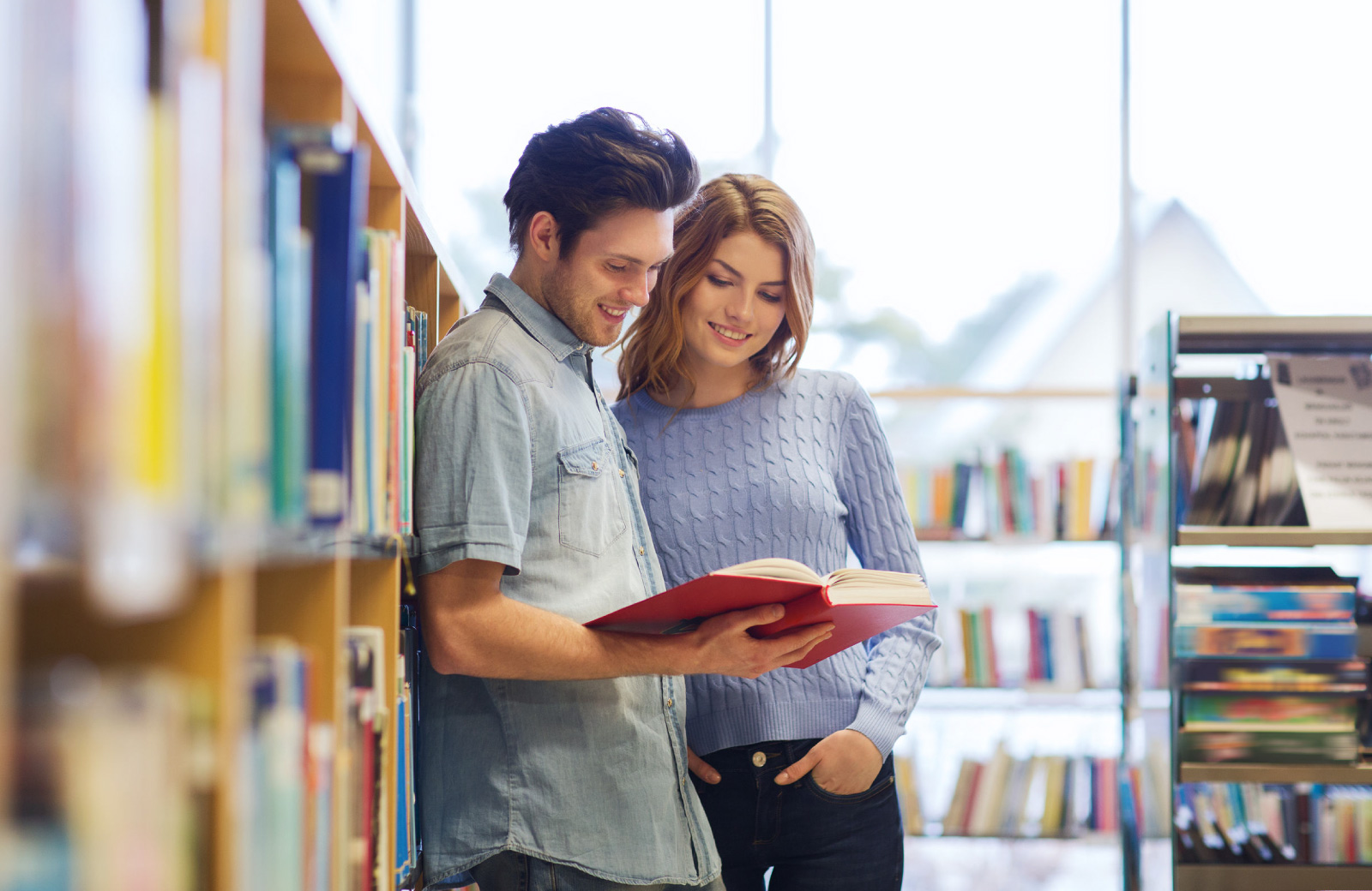 couple reading a book in a library