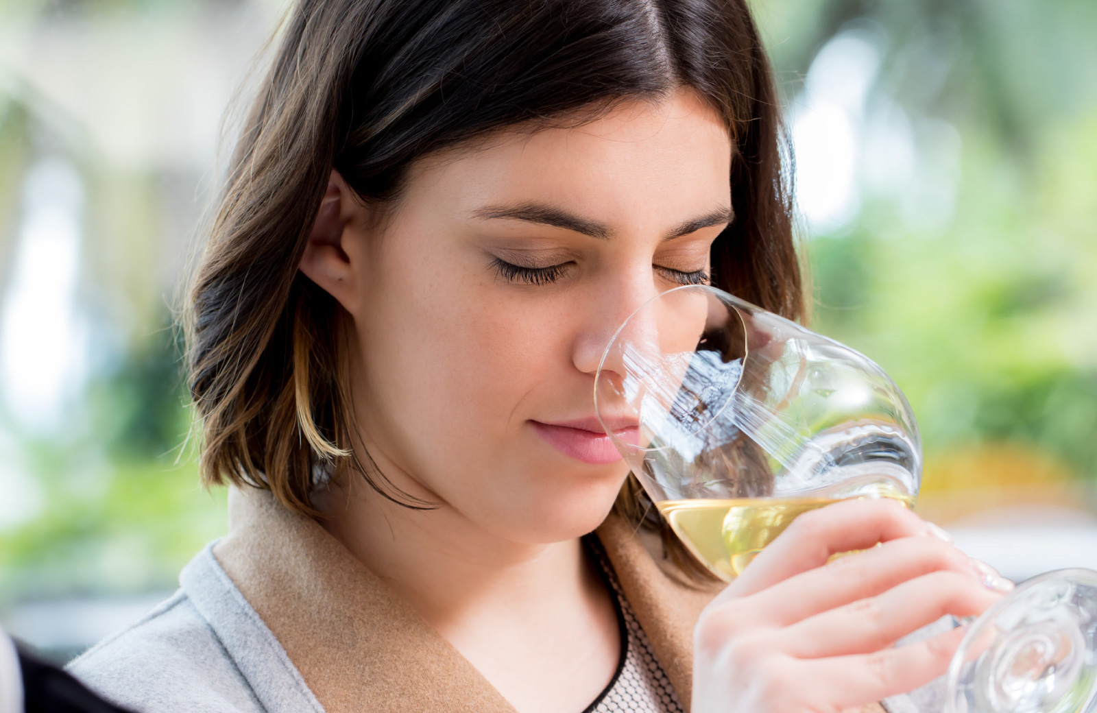 woman smelling white wine