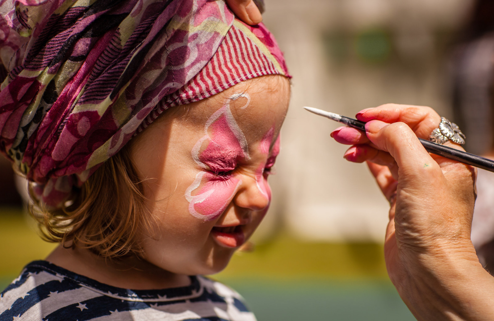 little girl getting face painted