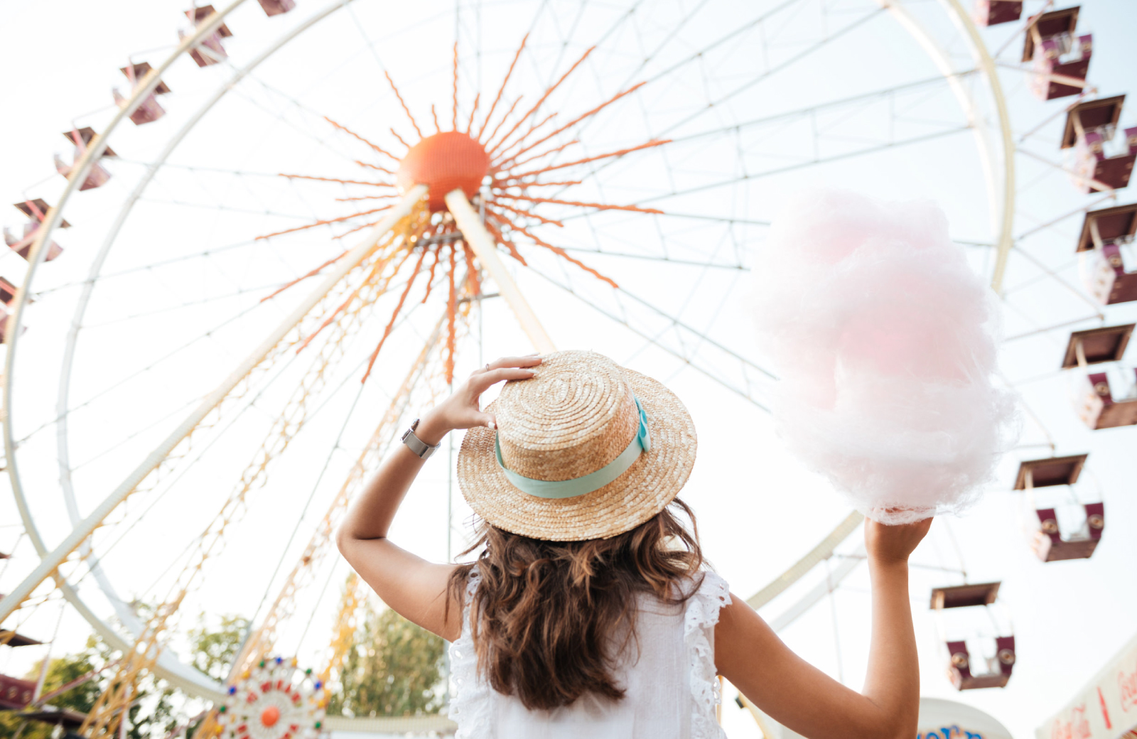 woman in front of a ferris wheel