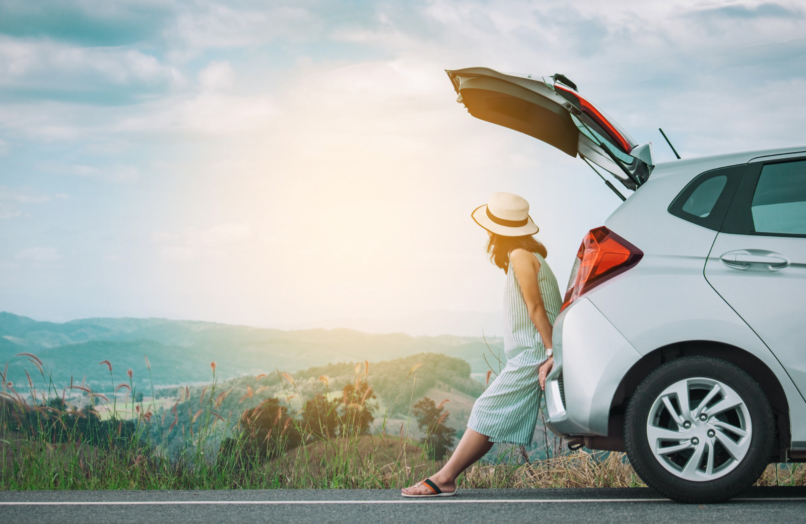 woman looking at a view at the back of her car