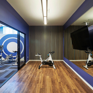 A spin cycle in an exercise room with wall mirrors