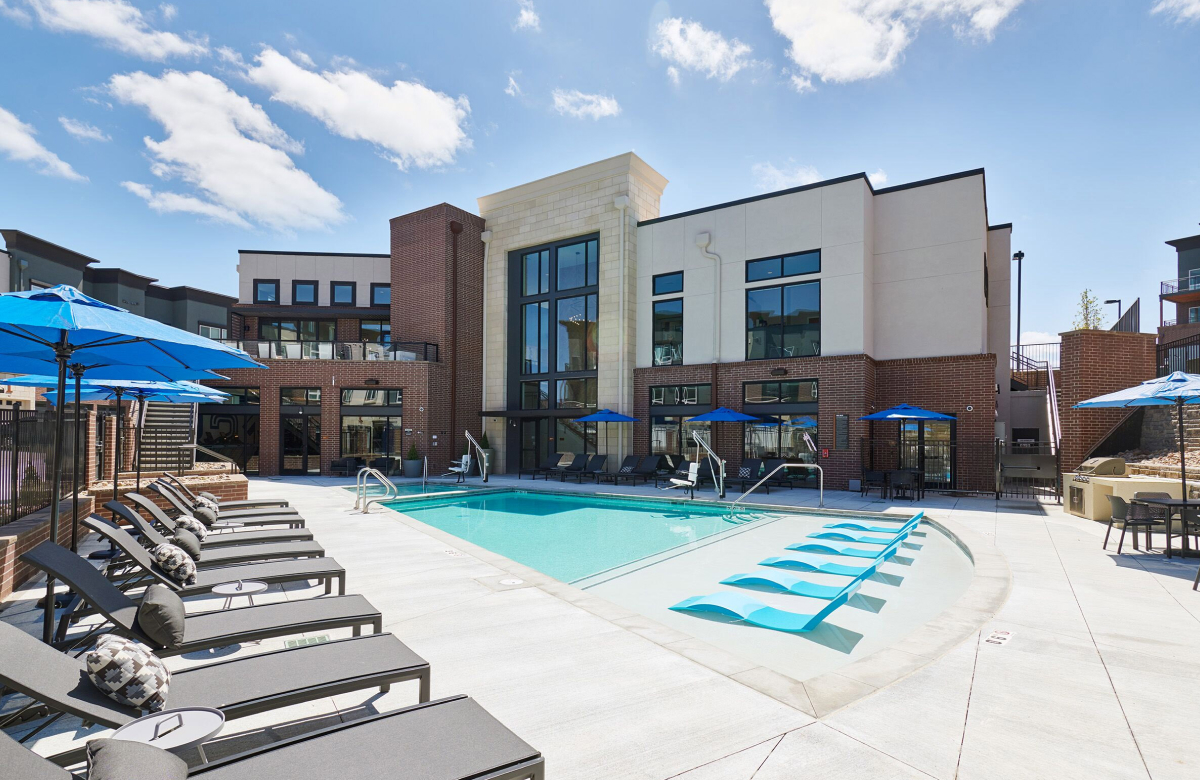 The Palmer apartment amenities - outdoor pool with lots of lounge chairs