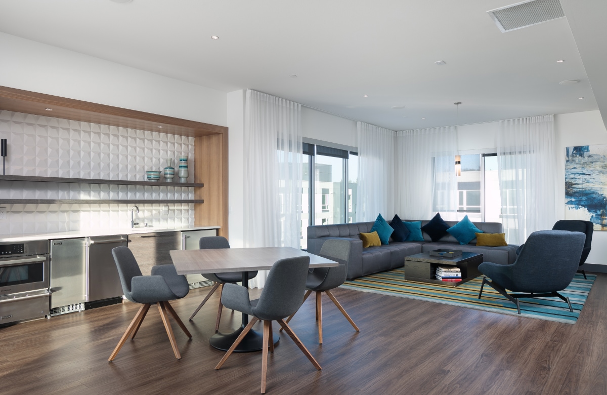 Open plan, modern living space with lounge, kitchen and dining.