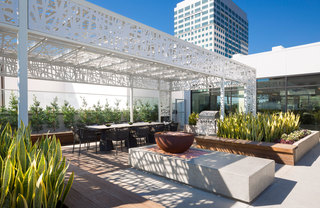 Outdoor dining area and bench seating near a fire pit