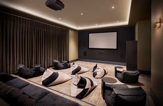 Billiard tables in a room with a flat-screen TV