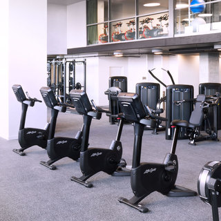 Rows of stationary bikes and other exercise machines in the fitness center
